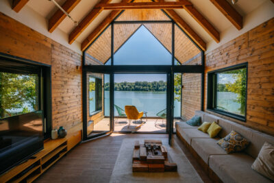 A scenic view of the waterfront from inside of weekend cottage by the riverside